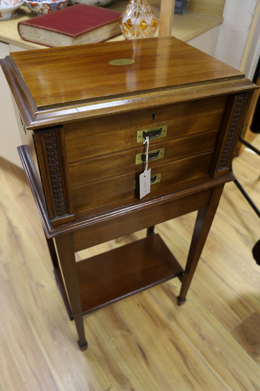 A mahogany cased canteen of cutlery and stand